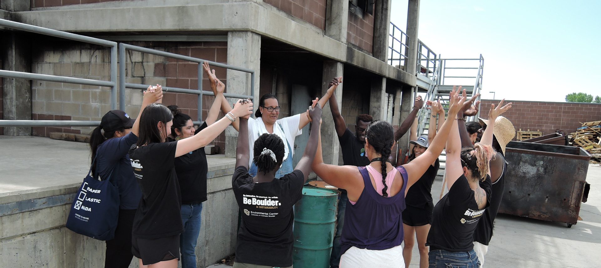 FLOWS members in a circle with their hands up